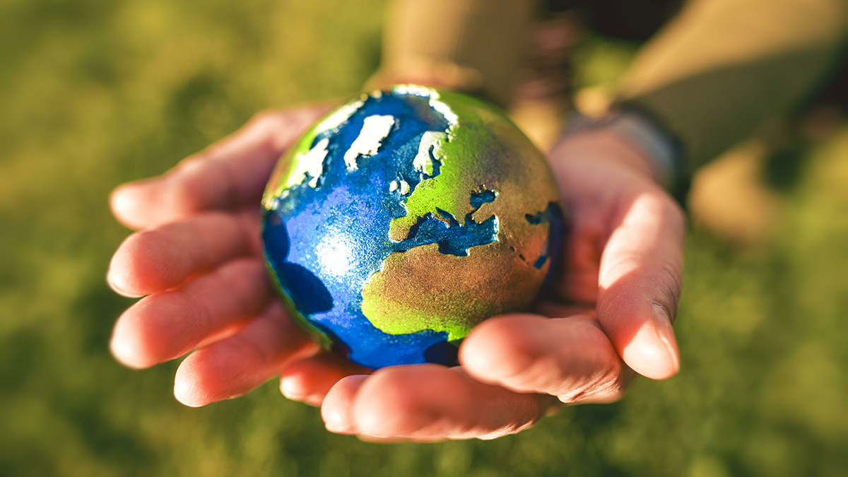 Klimaschutz: Zwei Hände halten ein Modell der Weltkugel